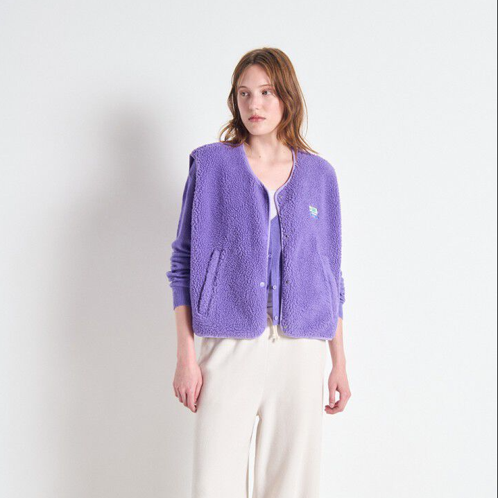 Woman wearing a purple cardigan on a white background