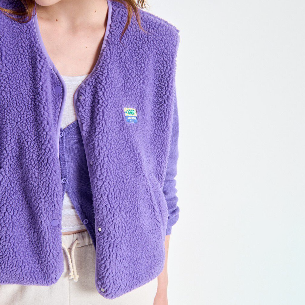 Purple fleece vest with a brand logo on a white background