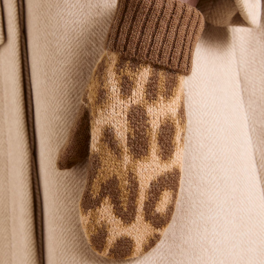 Leopard print knitted mitten on a beige background